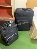 Pair of black rolling suitcases