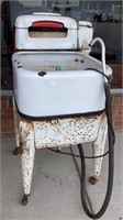 Old time enamel washer with agitator on rolling