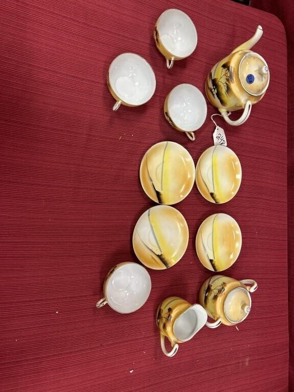 Porcelain oriental tea set in yellow with tree