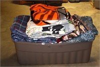 Large container of throws, blankets, comforters