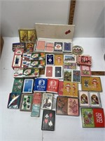 Box of assorted playing cards & poker chips