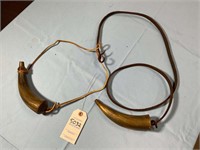 TWO POWDER HORNS MISSING PLUGS ON SLINGS WITH SOME