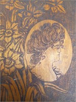 Portrait in oval with flowers wood carving burning