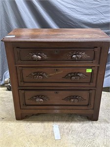 Three-drawer cherry nightstand with carved acorn h