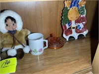 Decorative items including Eskimo doll, baby shoes