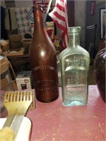 Pair of old bottles. Brown bottle made in