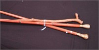 Three walking sticks: two with metal handles,