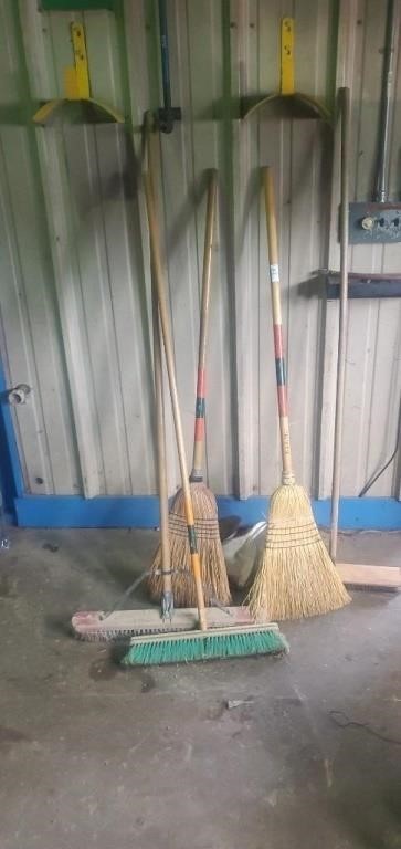 Lot of brooms,and hose holders