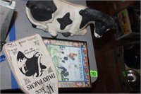 cow figuirine and 2 cow signs