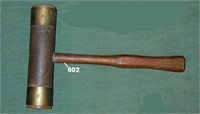 Wooden mallet with rubber faces in brass sleeves