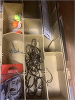 Plastic tackle box with some hooks, baits, etc.