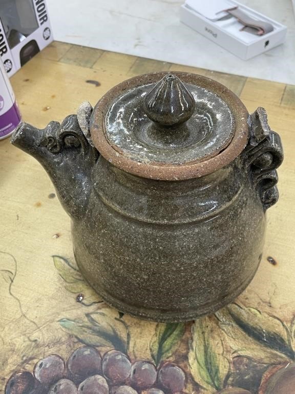 Clay teapot with handle broken off