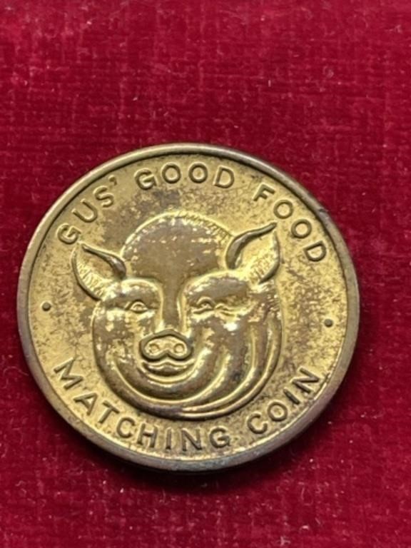 Pig Gus’ Good Food matching coin