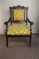 Antique carved, upholstered arm chair, front