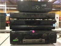 Stack of home theater electronics and more.