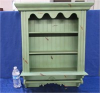 painted green wall cabinet with towel holder