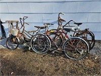 group of vintage bicycles and wooden sled