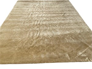 Large machine made rug with a gold tone