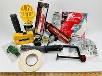 Work light, caulking gun, flashlight, tape