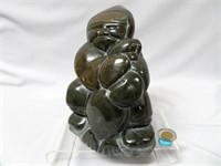 Inuit soapstone carving - man with seal, 8 1/2" h.