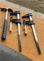 Saw, hammer, measuring tape, and clamps