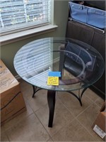 THERE ARE TWO ROUND GLASS AND METAL END TABLES