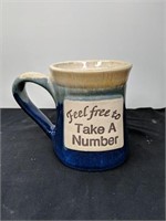 Feel free to take a number ceramic mug
