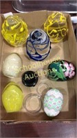Flat of glass egg paperweights, black ceramic &