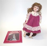 Vintage porcelain doll and book