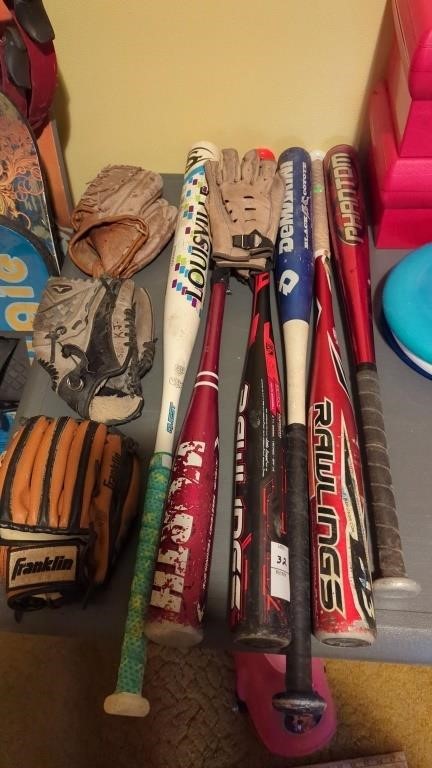 Lot of baseball gloves and bats