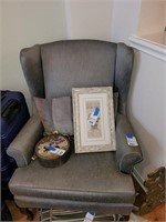 Gray wing back chair with pillow