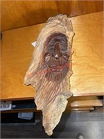 Heavy wood carving of man (living room)