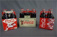 Three Cardboard Carriers with Bottles of Coke
