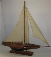 Wood sailboat replica on wood stand. Measures 29"