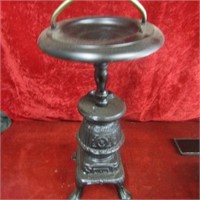 Cast stove shaped ashtray stand.