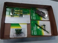 assortment of JD 1/64 scale implements