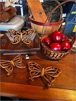 Basket of apples, candle snuff and butterflies