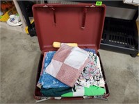 Suitcase of fabric yardage, needlepoint
