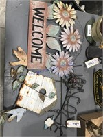 Tin cut-out welcome signs, flowers and birdhouse
