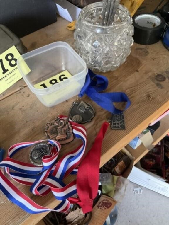 Various medals and glass jar