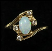 14K Yellow gold oval cabochon opal ring in bypass