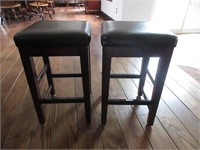 TWO PADDED UNDERCOUNTER STOOLS