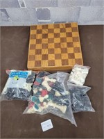 Wood game board with chess and other game pieces
