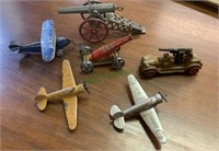 Antique iron metal toy planes and cannons, and a