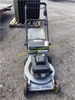 D1. John Deere push mower with bag runs