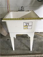 Plastic laundry sink with taps. 22” wide. 24”