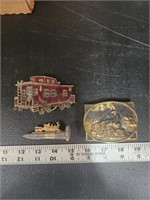 Train belt buckles and gold plated train on spike
