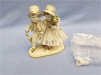 Porcelain figurine of young boy and girl