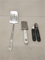lot of kitchen utensils- whisk, spoons, garlic