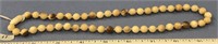 18" strand of fossilized ivory beads, with an ivor